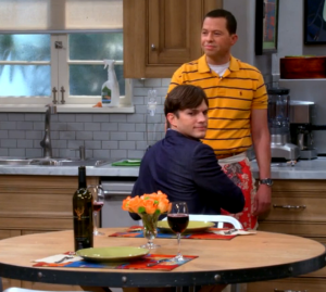 Walden (Ashton Kutcher) and Alan (Jon Cryer) with a wine from Brian Arden in Two and Half Man